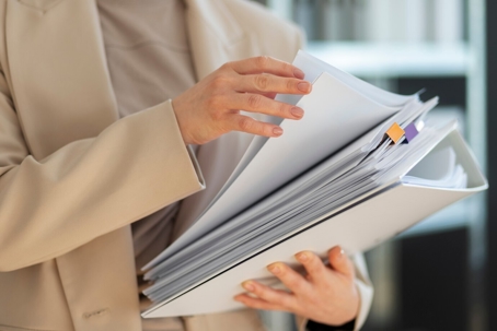 a person holding a lot of documents